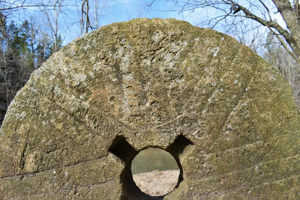 An old millstone is all that remains from a grist mill of olden days. 