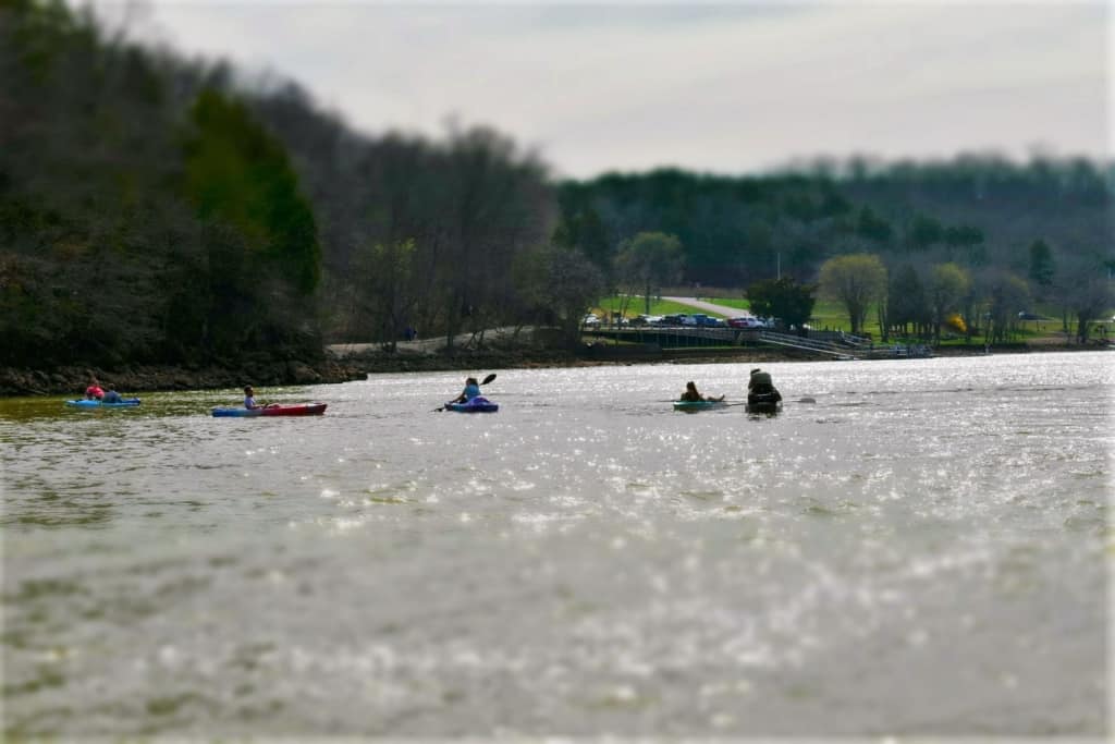 Kayakers paddle slowly across the waters that flow from ha Ha Tonka Spring. 