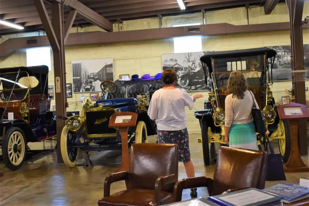 Katie explains some history about the vehicles at the Mitchell Car Museum.