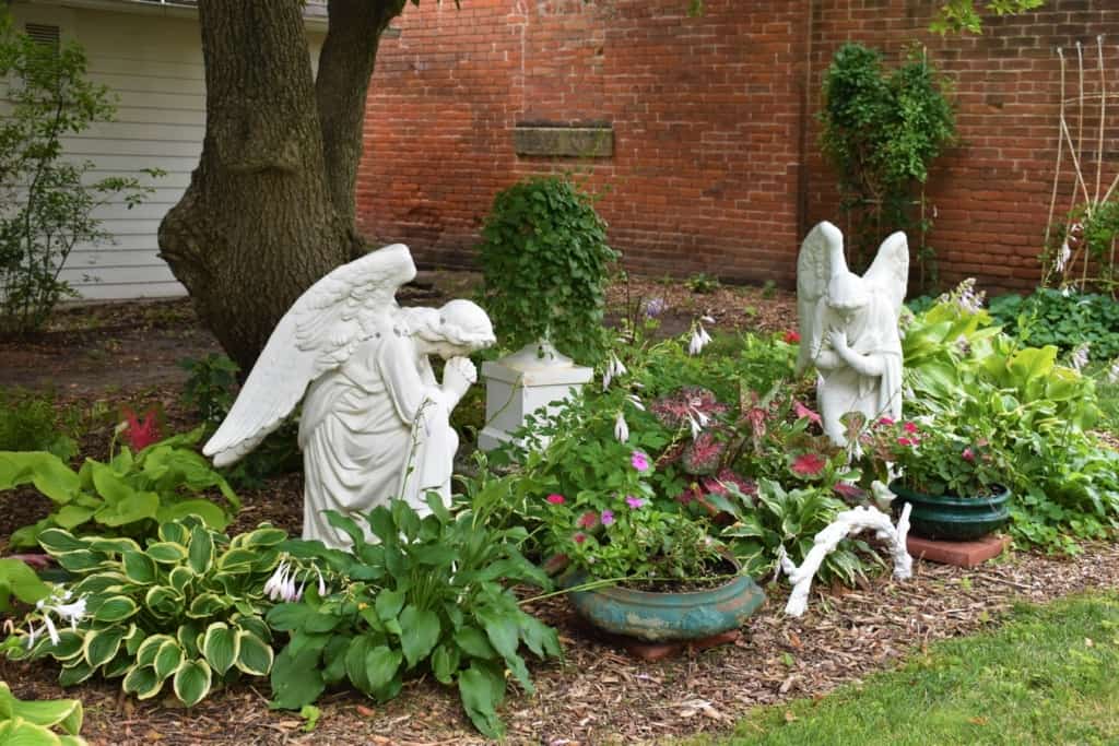 Winged angels stand guard in the gardens at the Koester House.