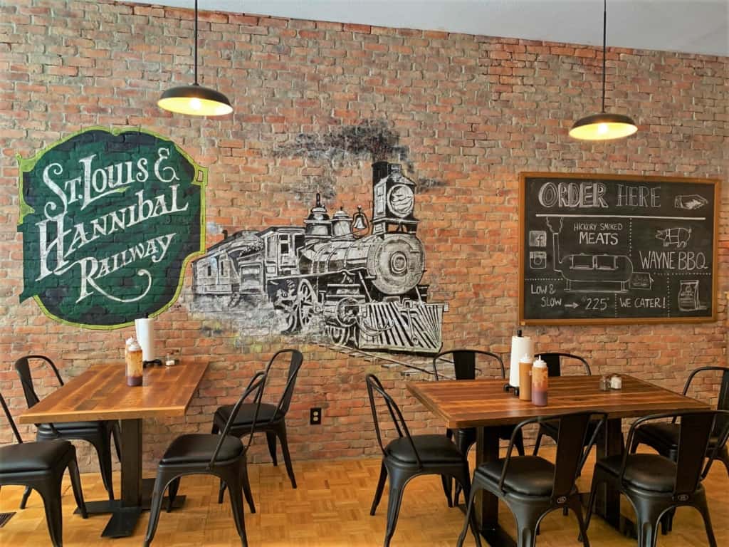 the exposed brick wall makes a good canvas for decorating the interior of Wayne's BBQ in Hannibal, Missouri. 