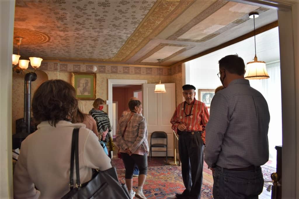A native guide tells visitors about the life of the family who lived in the Scholte House Museum.
