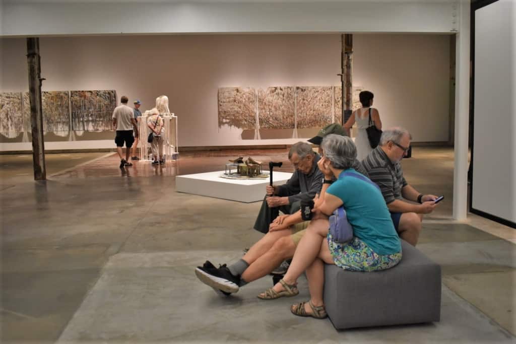 Visitors take a break from the summer heat to enjoy the artwork on display at The Momentary in Bentonville, Arkansas. 