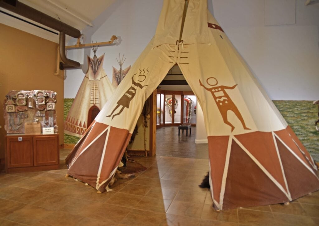 A teepee is used to separate galleries inside the MONAH.