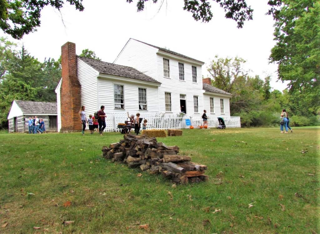 Visitors explore the various buildings that are found on the grounds of Missouri Town 1855.