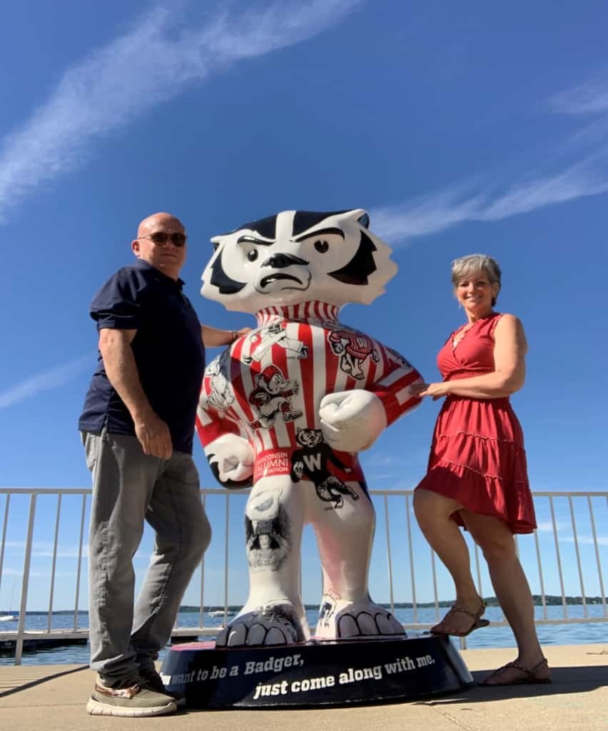 The authors pose with the University of Wisconsin mascot. 