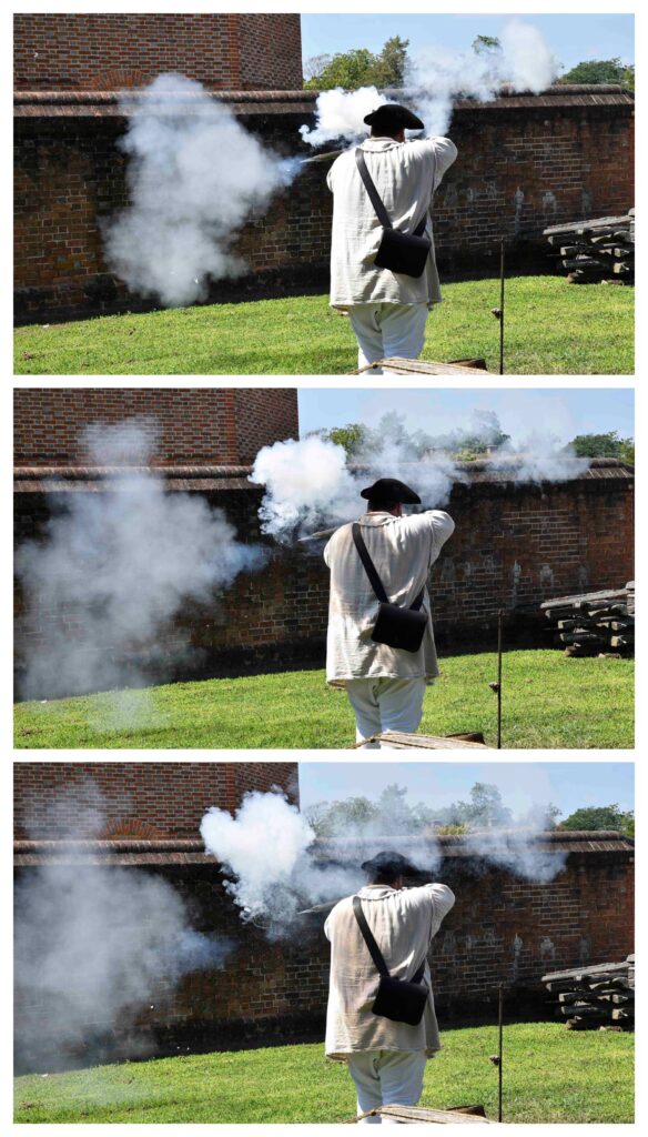 An interpreter demonstrates firing a flintlock rifle.