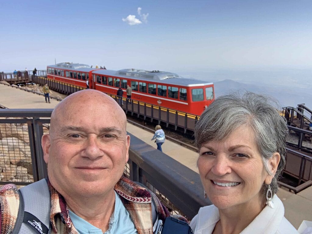 The authors pose in front of the Pike's Peak Cog Railway.