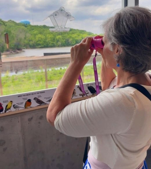 Crystal scans the horizon for wildlife during a visit to the Rivers Edge Discovery Center.