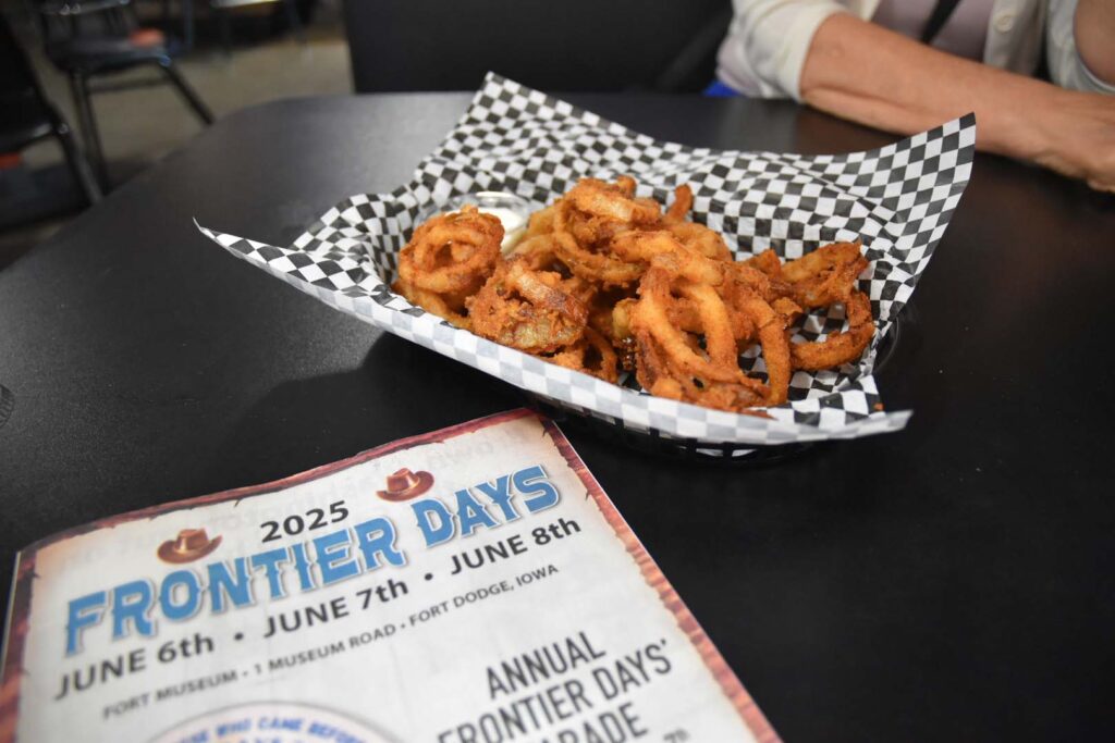 A basket filled with O' Rings and an event calendar from Frontier Days.
