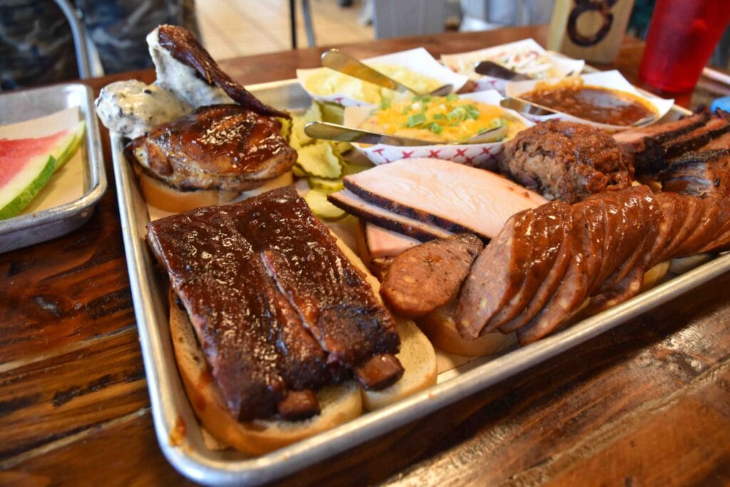 The Sampler Platter is stacked with an abundance of smoked meats.