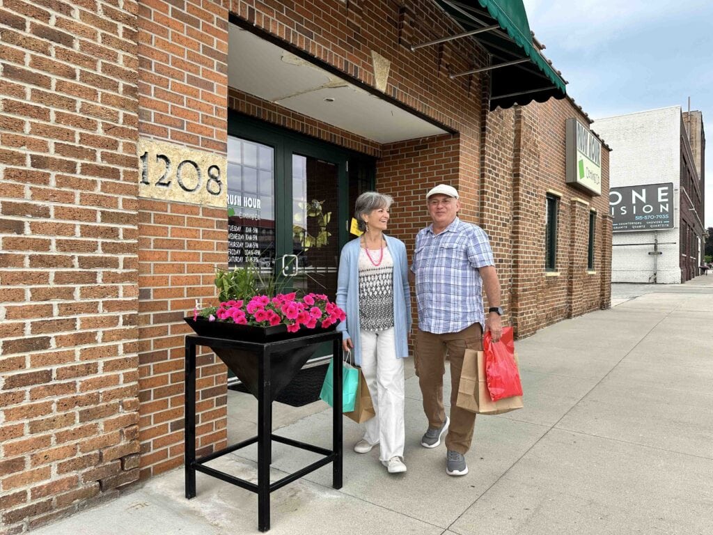 The authors carry their purchases after shopping at downtown Fort Dodge boutiques.