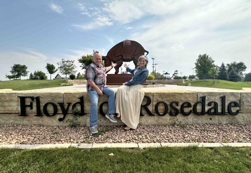The authors pose with the statue of Floyd of Rosedale, which is a pig that gained notoriety in Fort Dodge, Iowa.