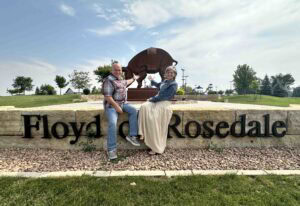 The authors pose with the statue of Floyd of Rosedale, which is a pig that gained notoriety in Fort Dodge, Iowa.