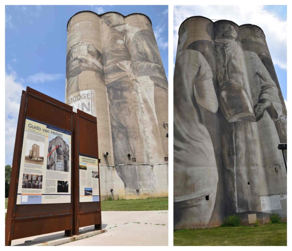 A huge grain silo that has been painted with a mural showing various Fort Dodge residents.