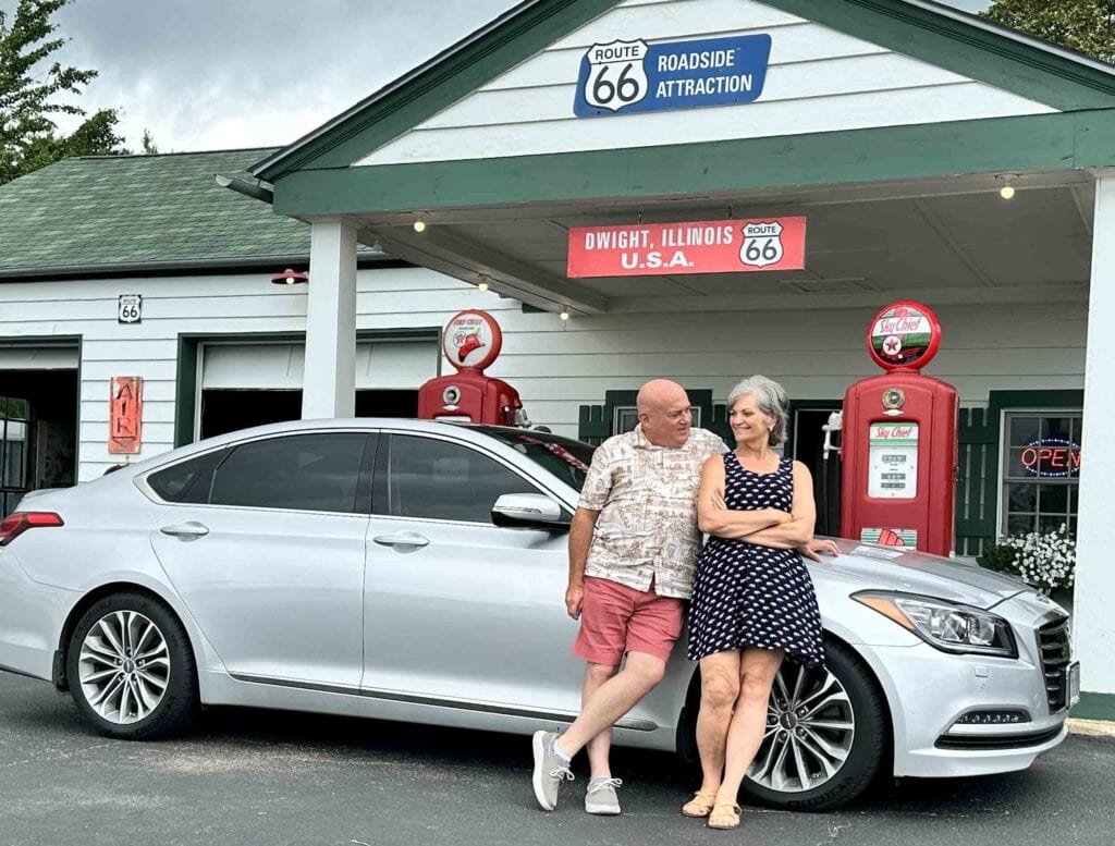 The authors posing with their car at the pumps in Dwight, Illinois.