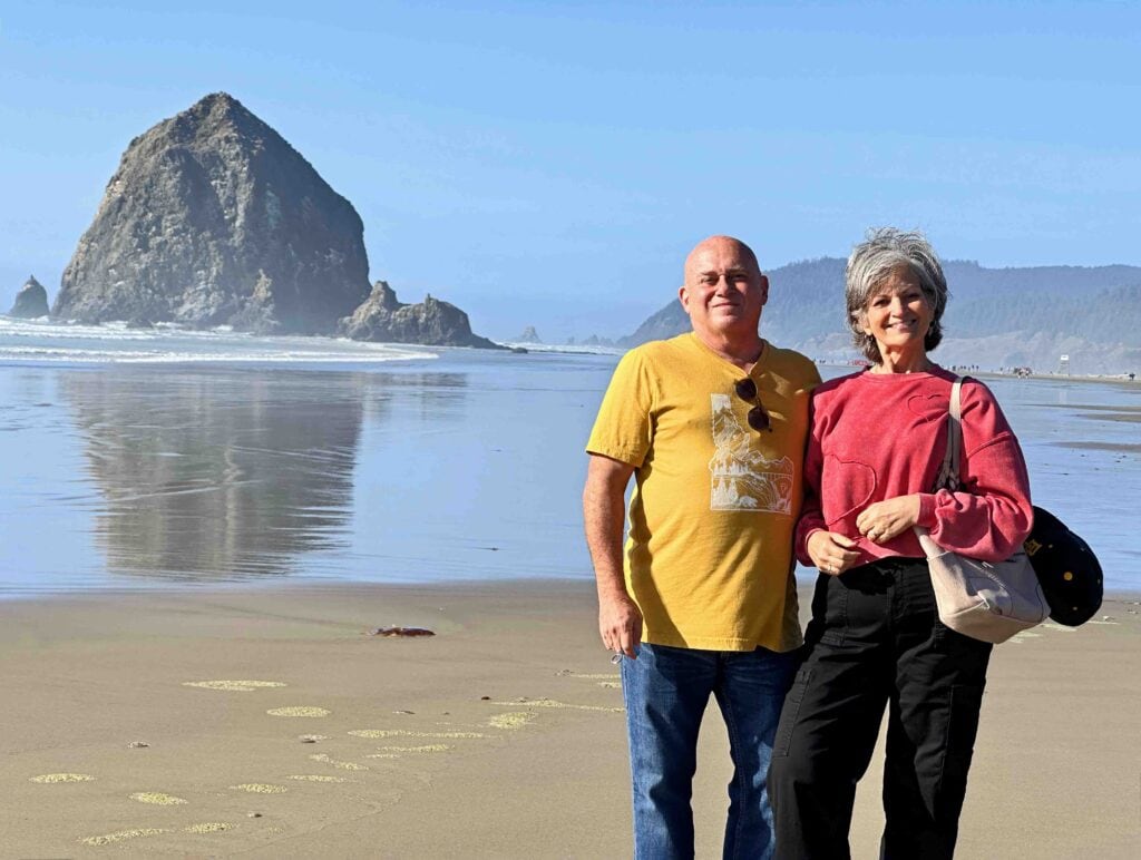 The authors posing in front of Haystack Rock.