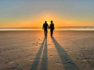 The authors take a sunset walk during their Oregon Coast road trip.