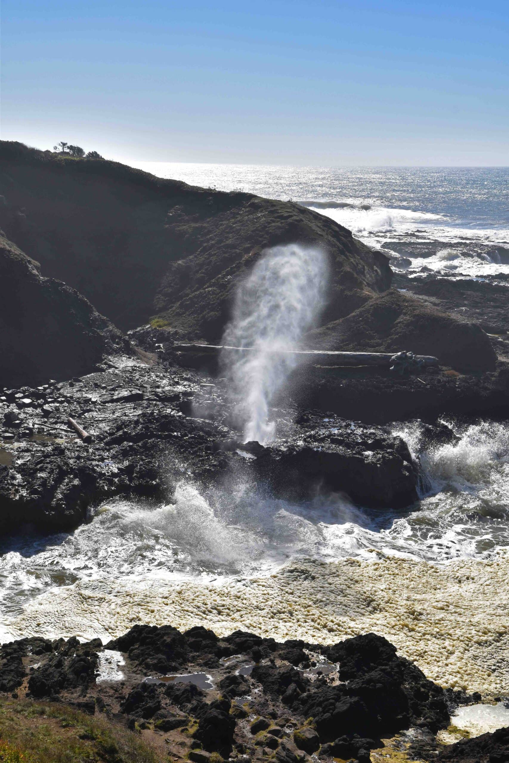 A natural blowhole is fun to watch, as the surf pushes mist toward the sky.