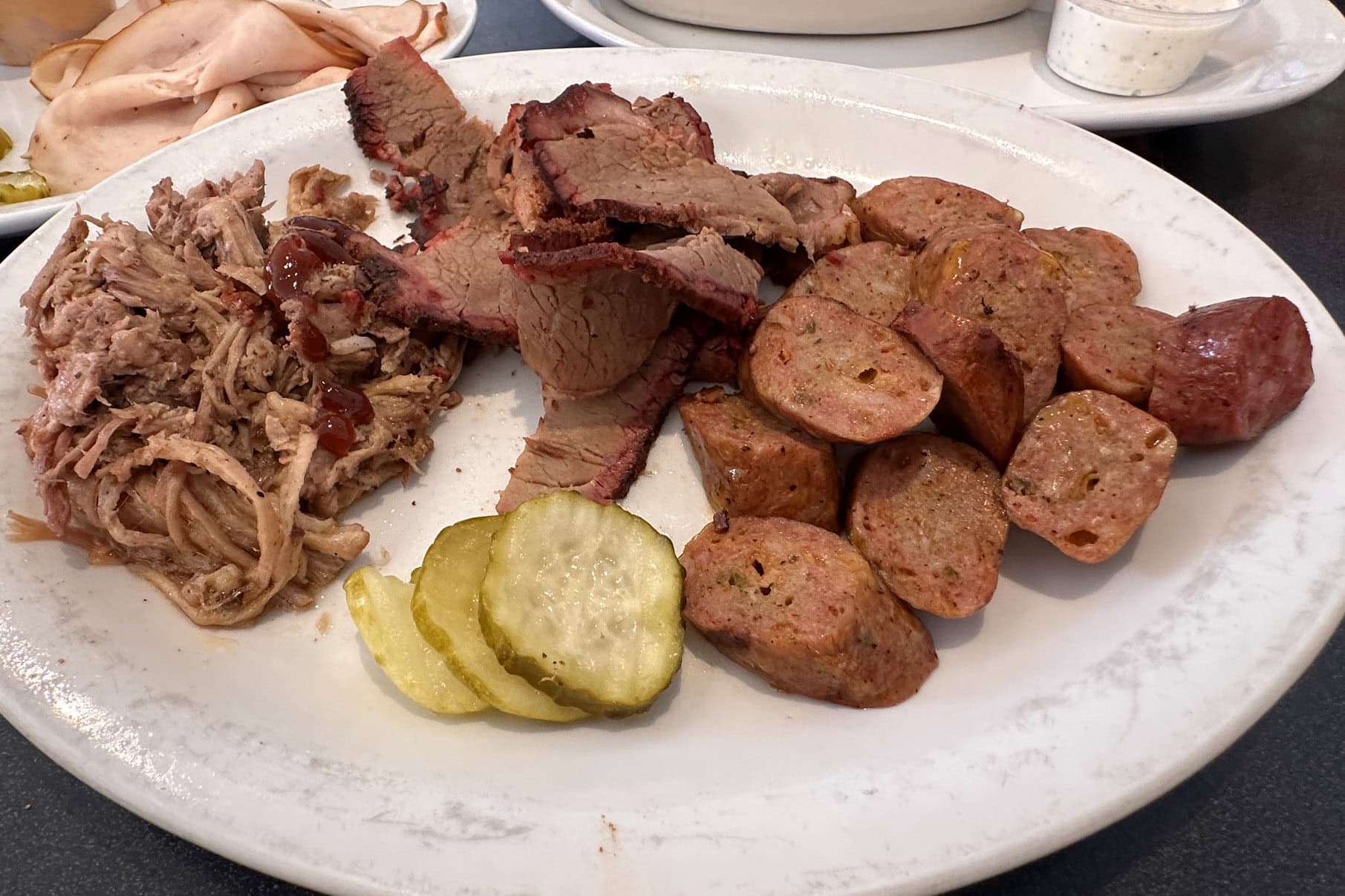 A plate full of smoked meats from Brobeck's Barbeque.